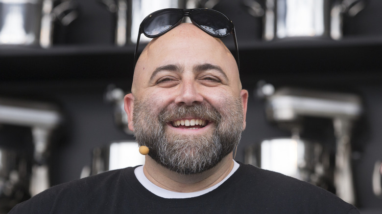 Duff Goldman smiles with sunglasses on at a cake event