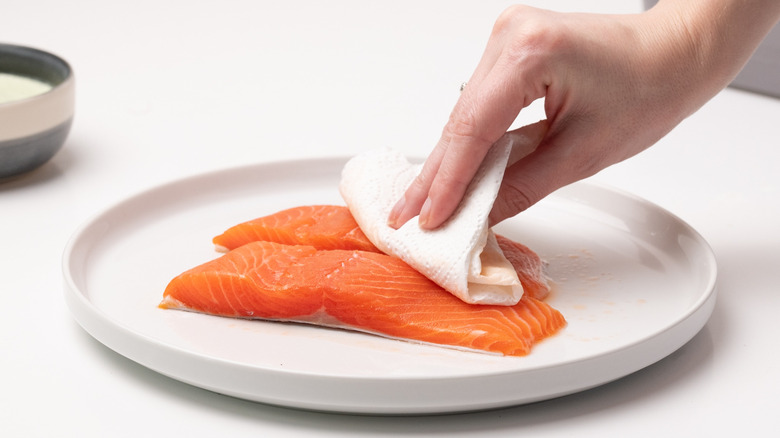 drying trout with paper towel