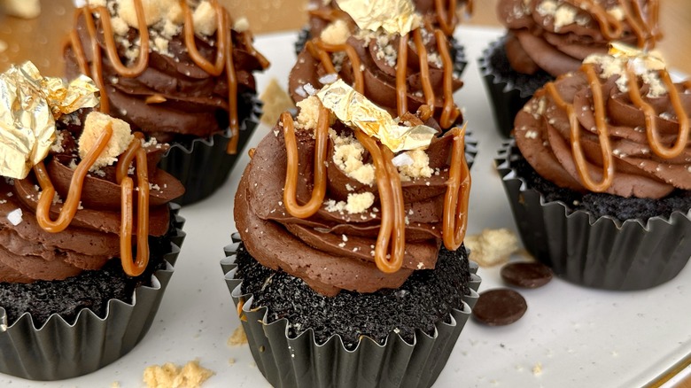 Serving dulce de leche-stuffed millionaire cupcakes