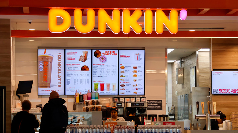 Exterior of Dunkin' location with menu on display