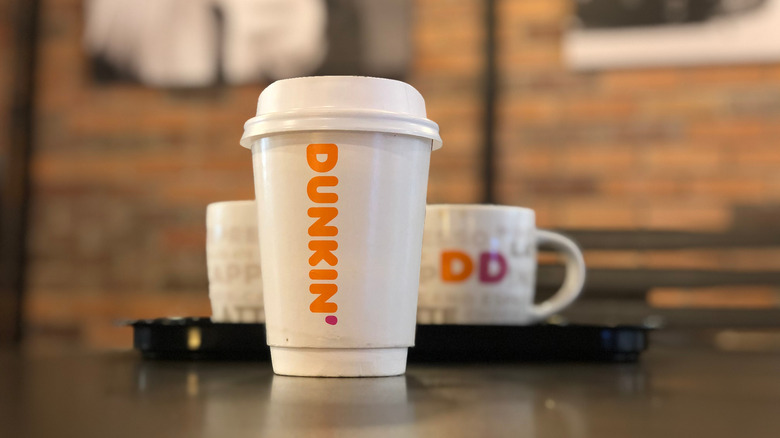 Dunkin' hot chocolate with raspberry on counter