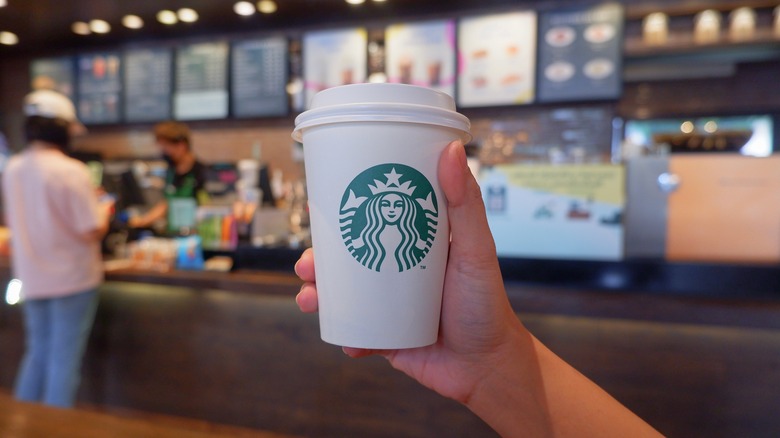 Person holding Starbucks beverage