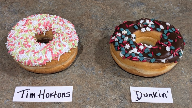 Tim Hortons donut with pink and white sprinkles, and Dunkin' chocolate-frosted donut with red, white, and blue sprinkles