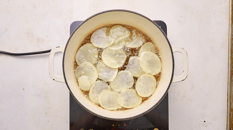 frying potato slices in oil