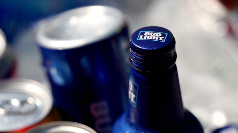 Bud Light bottle and can on ice