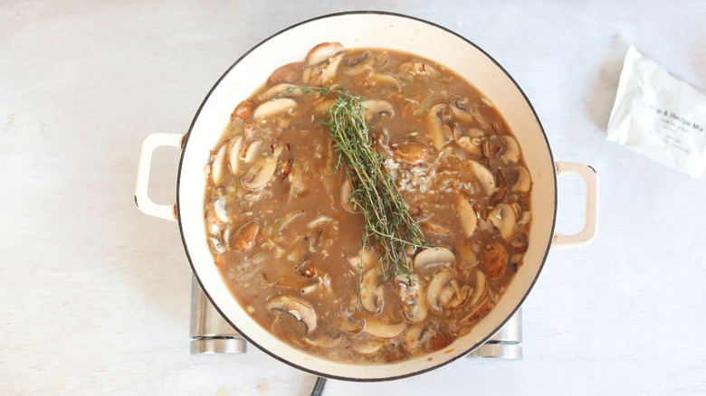 thyme and broth with rice in a pan