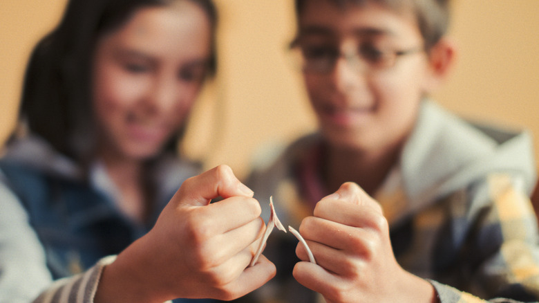 Children pulling wishbone apart