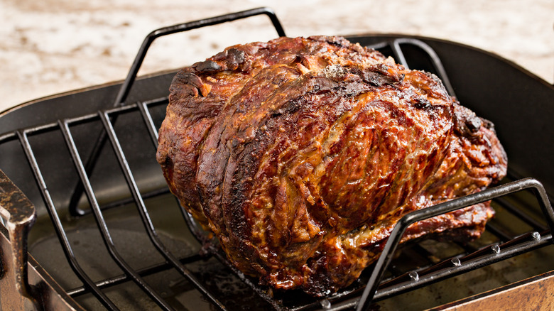 Roast sitting on a rack in a roasting pan