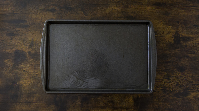 greased baking sheet on table