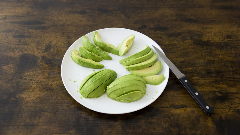 sliced avocado wedges on plate 