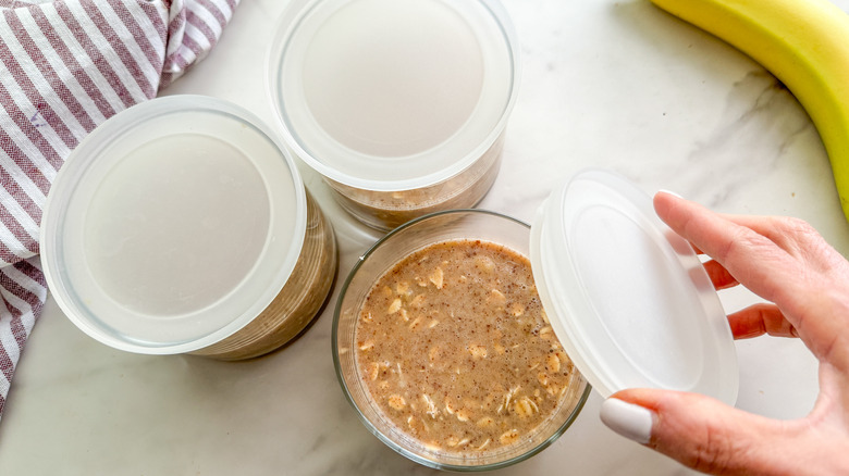 putting lid on jar of oats