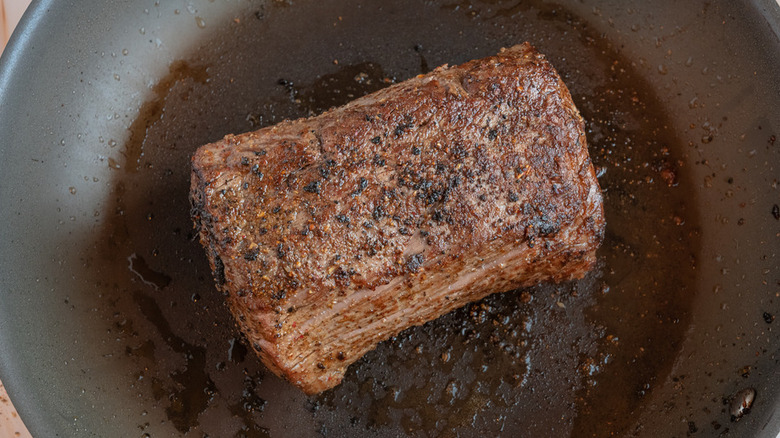 beef searing in pan