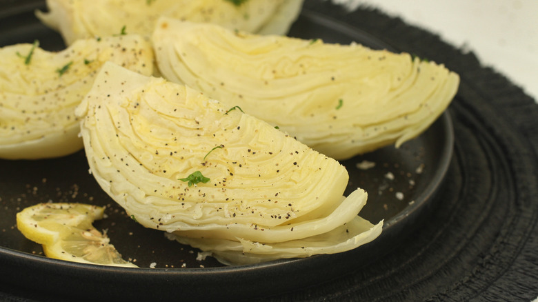 boiled cabbage on black plate