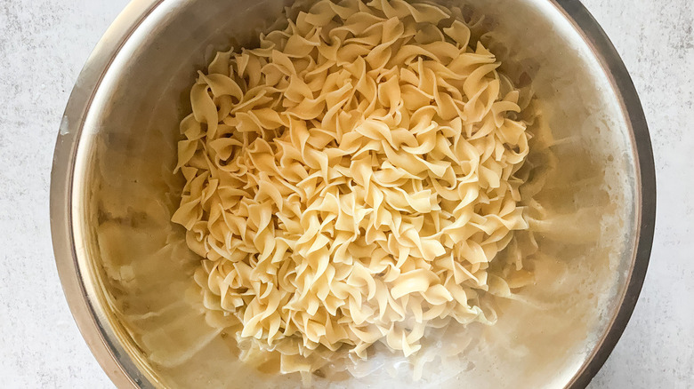 curly egg noodles cooked and in a bowl