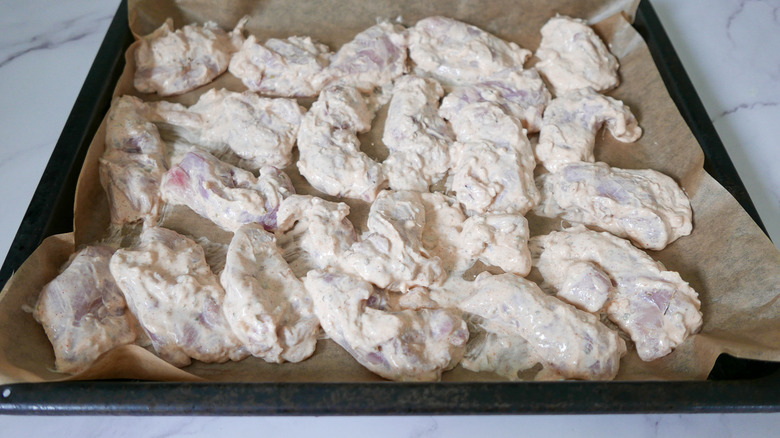 marinated chicken on baking tray