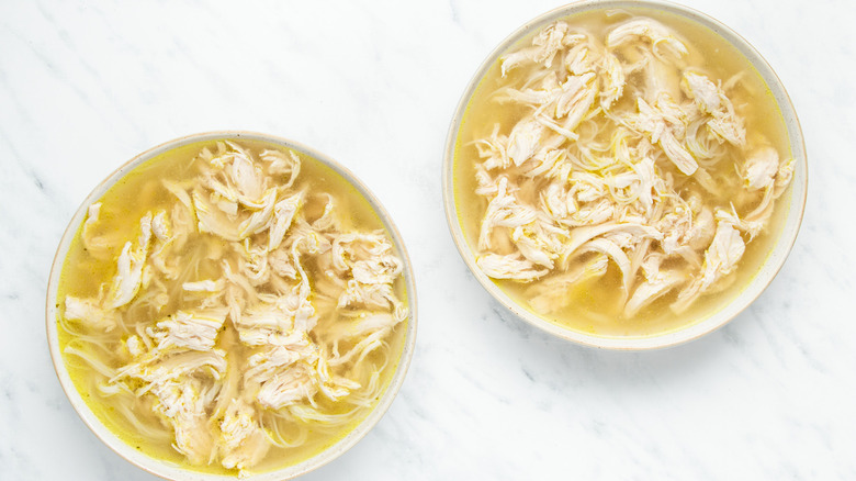 chicken and broth in bowls 