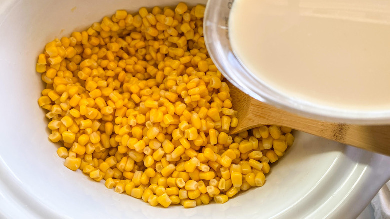 corn kernels in colander and crockpot