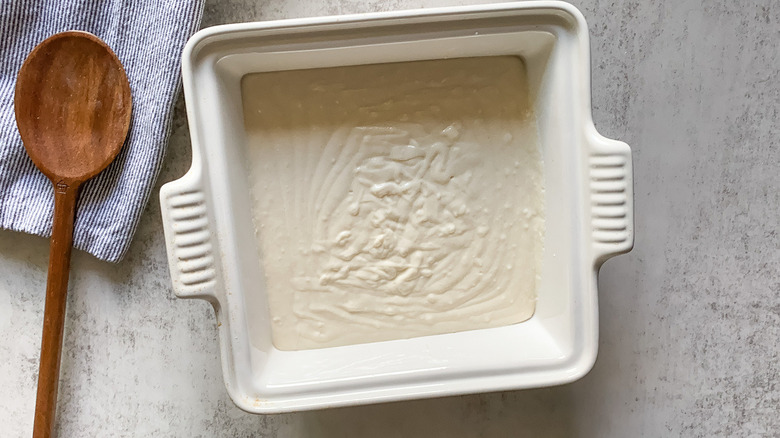 dewberry cobbler batter in baking pan 