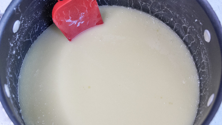 milk and spatula in pot