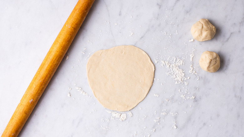 rolling out tortillas