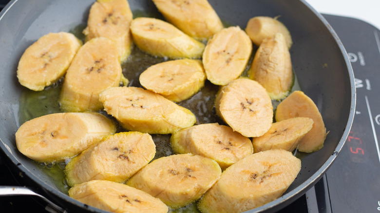 plantain slices in frying pan