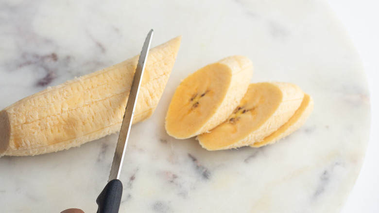 slicing plantain on diagonal