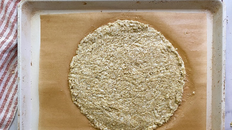 pizza dough baked on baking tray