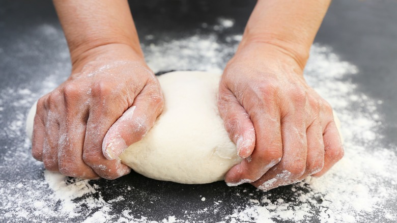 hands kneading dough