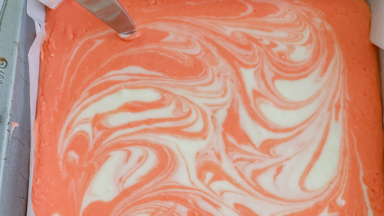 swirling orange white fudge mixture