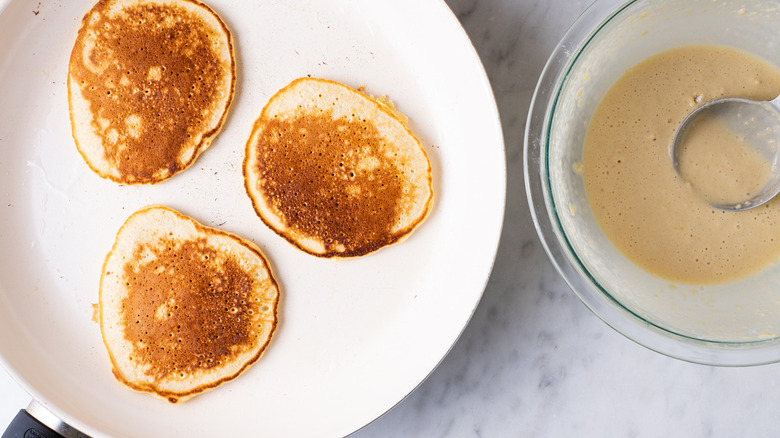 pancakes cooking in a skillet