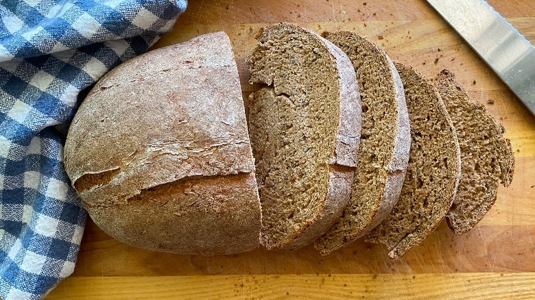 pumpernickel bread sliced on board