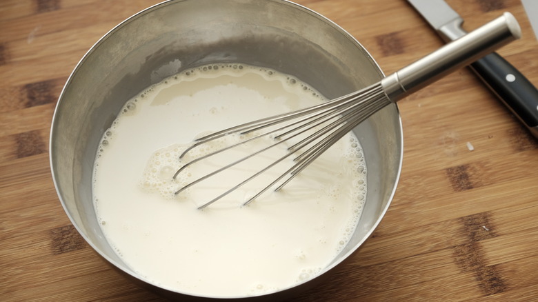 milk with whisk in bowl