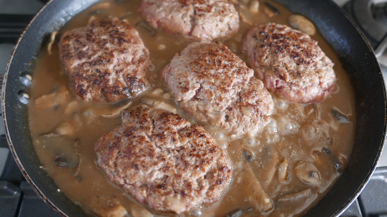 salisbury steaks and sauce in pan