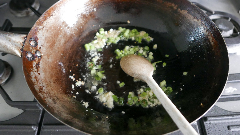 stir-frying alliums in wok