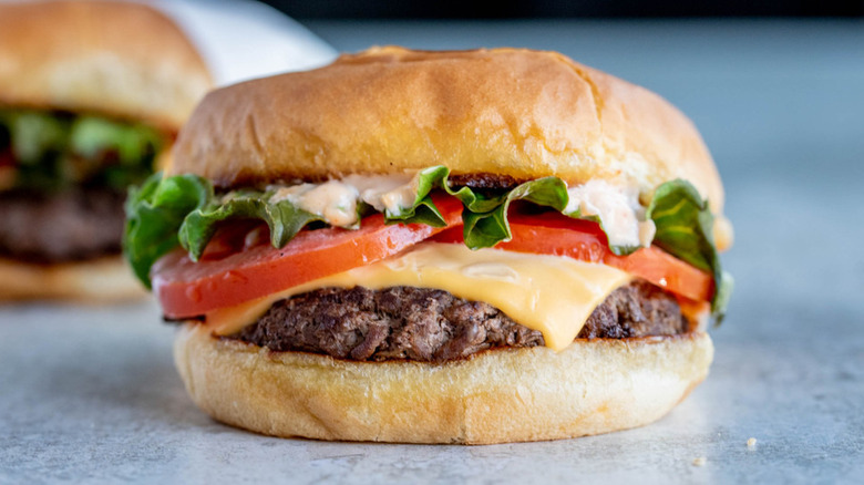 cheeseburger with tomatoes and lettuce