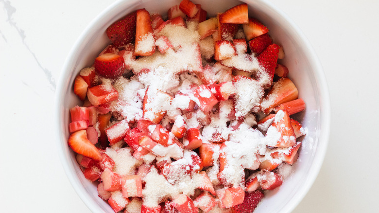 strawberries and rhubarb in bowl with sugar and starch