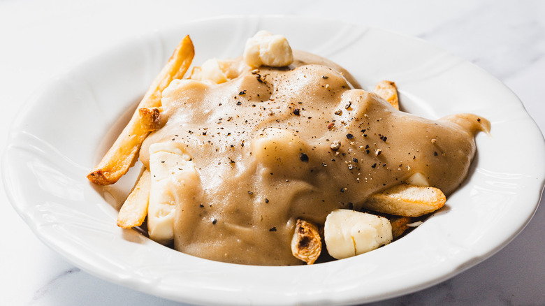 Plate of poutine with gravy and cheese