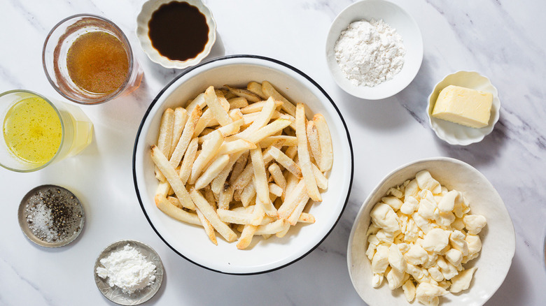 Classic poutine ingredients on marble counter