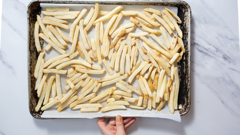 Raw fries on baking sheet