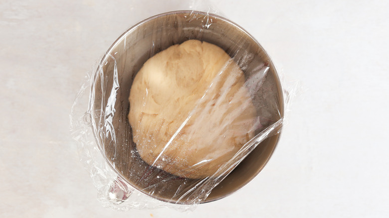 croissant dough rising in a bowl