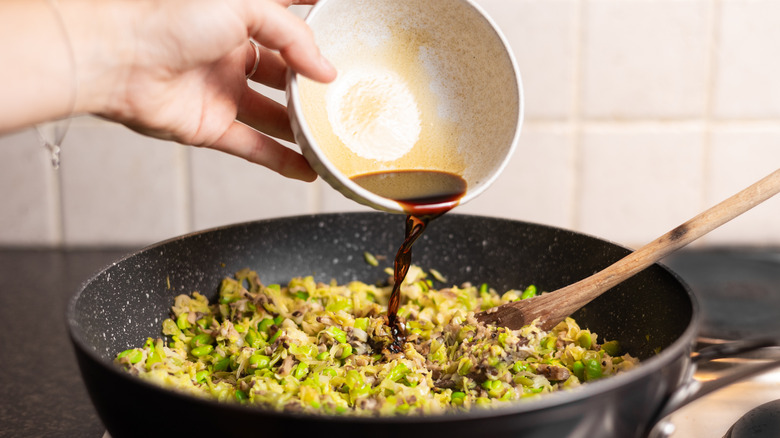 soy sauce going into pan 