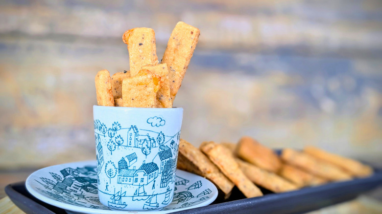 cheese straws displayed in cup and saucer