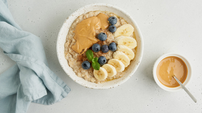 Bowl of oatmeal with peanut butter and fruit