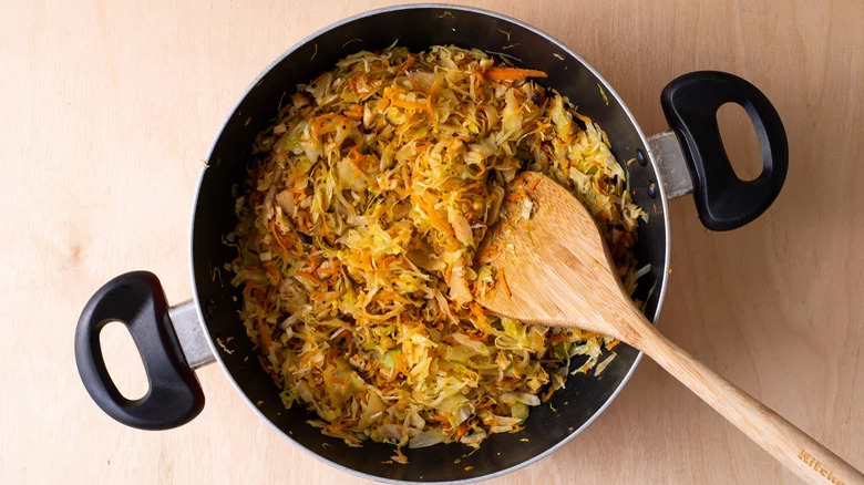 Top-down view of egg roll fillings in a pan