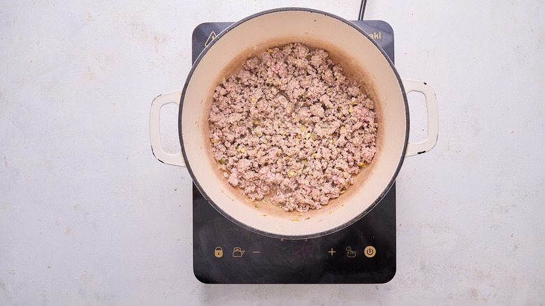 browning the pork in a pot