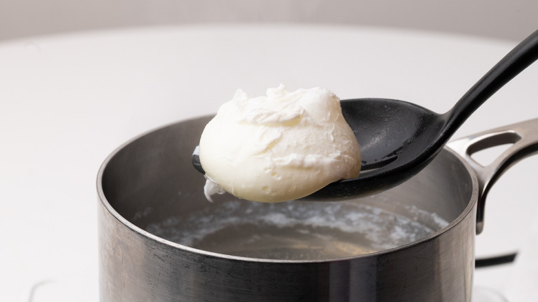 Removing poached egg from pan