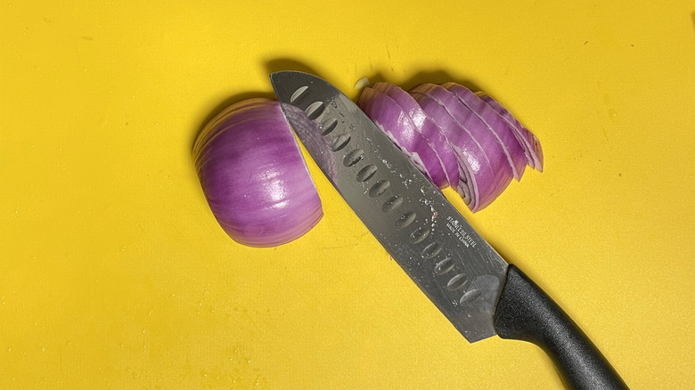 chopped red onion with knife