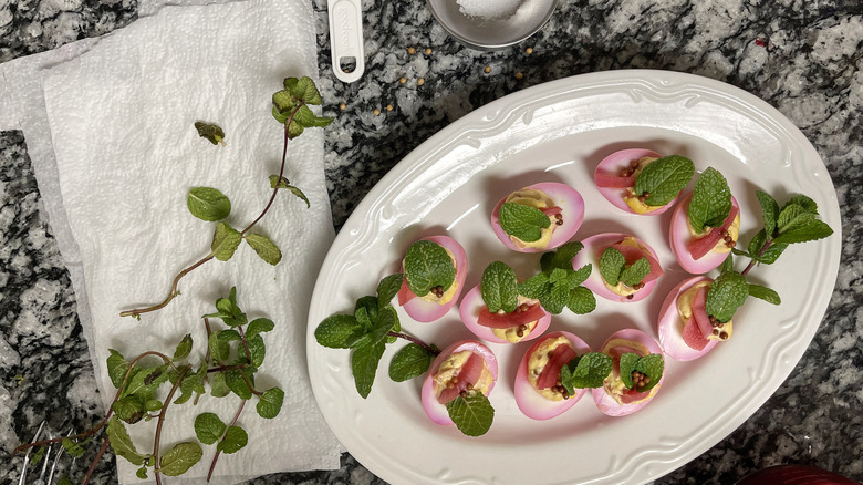 pink easter deviled eggs on platter