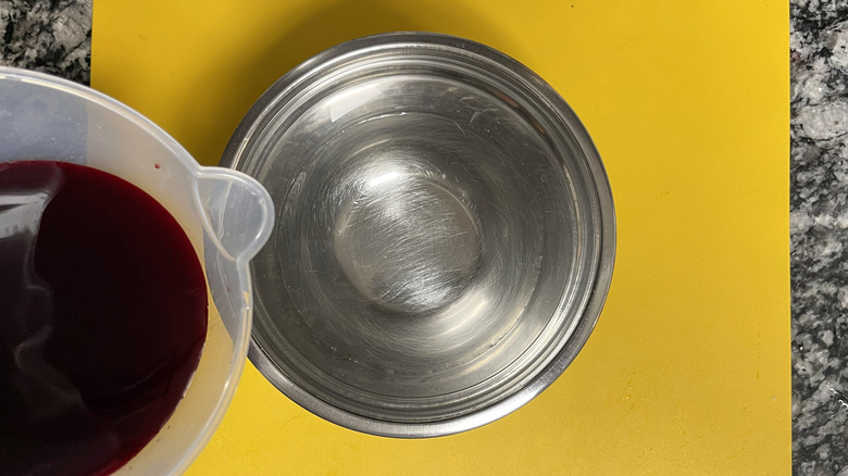 pouring beet juice into vinegar