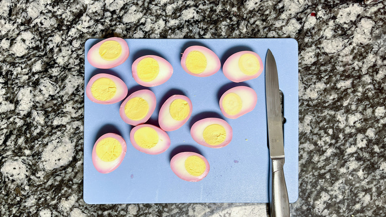 hard-boiled egg halves on cutting board